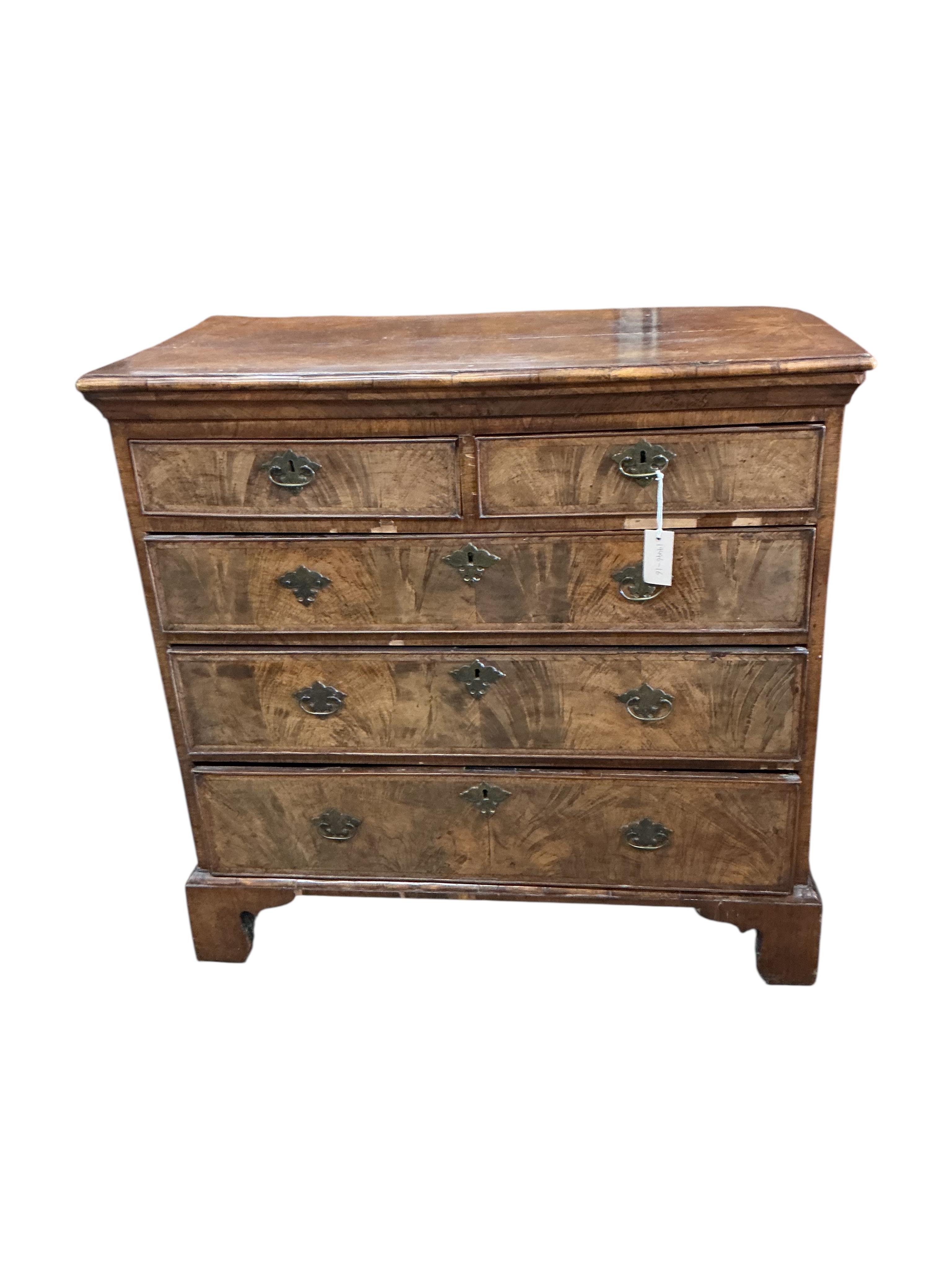 A George II feather banded walnut chest of drawers, width 94cm, depth 48cm, height 92cm